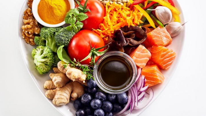 A pile of different types of vegetables on a white surface